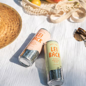 A can of Lei Back Guava Sparkling Water next to a can of Lei Back Pomelo Sparkling water