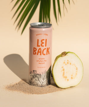 A can of Lei Back Guava Sparkling Water next to a bisected guava fruit